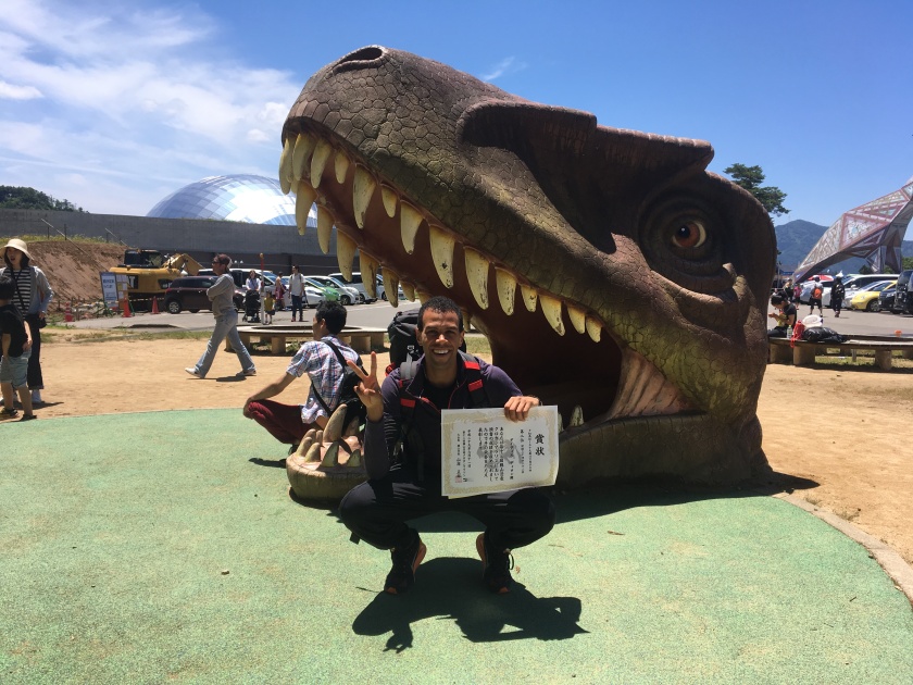 dillon in front of dinosaur head at katsuyama marathon
